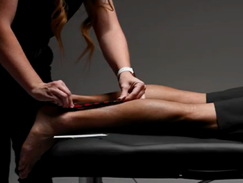 Infrared Kinesiology Tape being placed on a person's calf