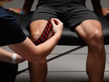 Infrared Kinesiology Tape being placed on a person's knee